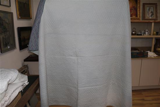 An off-white quilt with blue stitching, a reversible blue and cream quilt, a creamy oyster quilt and a mint green quilt (4)